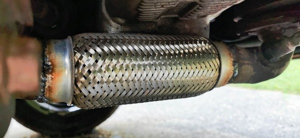 Exhaust flex pipe installed on a vehicle by welding.