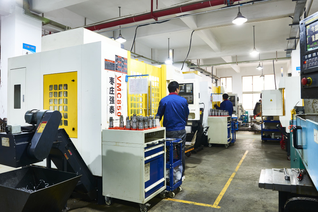 Technician Operating Advanced Stamping or Welding Equipment for Exhaust Clamps