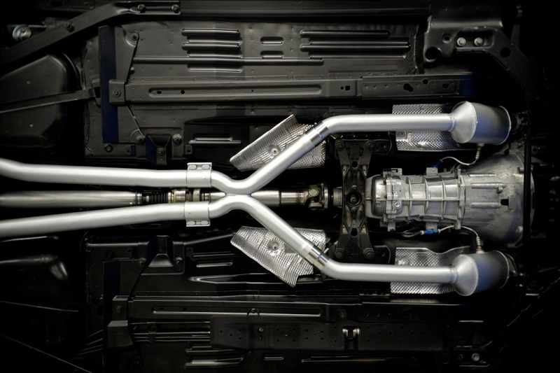 Automotive exhaust system showing rigid pipe sections and connected components